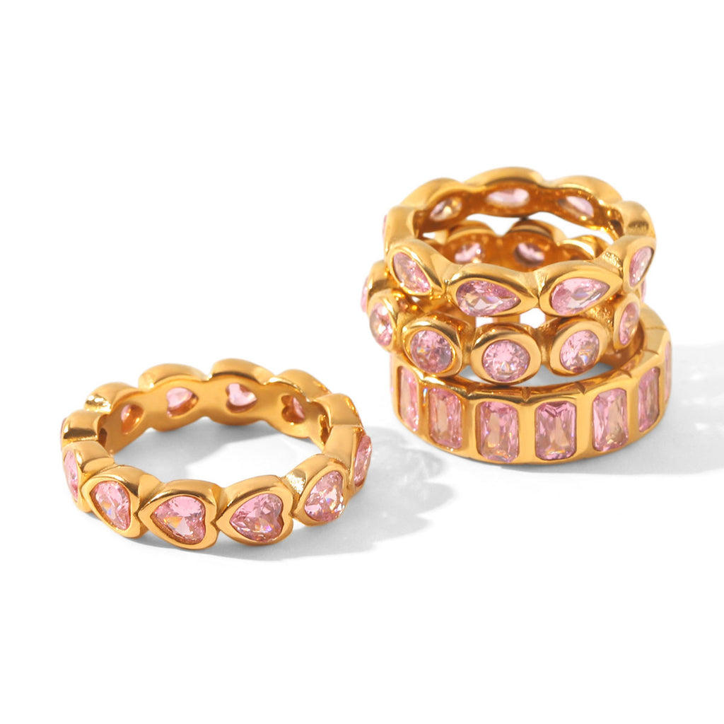 Anillo de Acero con Zirconias Rosadas en Canal Dorado